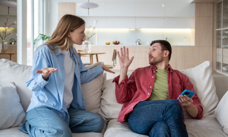 A distressed husband and wife sitting apart, reflecting emotional distance and conflict.
