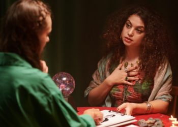 Astrologer studying zodiac signs and star charts for divine insights.
